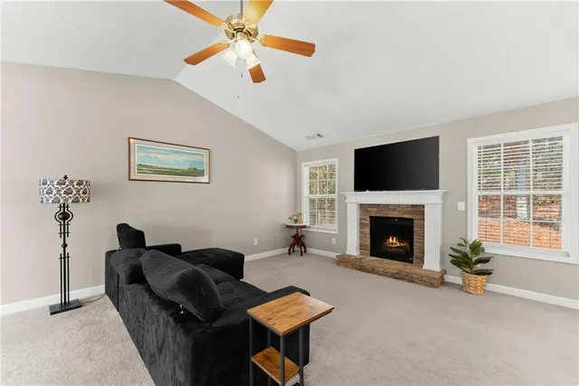 a living room with furniture a window and a flat screen tv