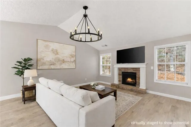 a living room with furniture and kitchen view