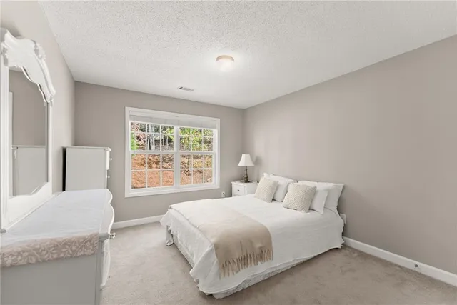 a bedroom with a bed and a large window