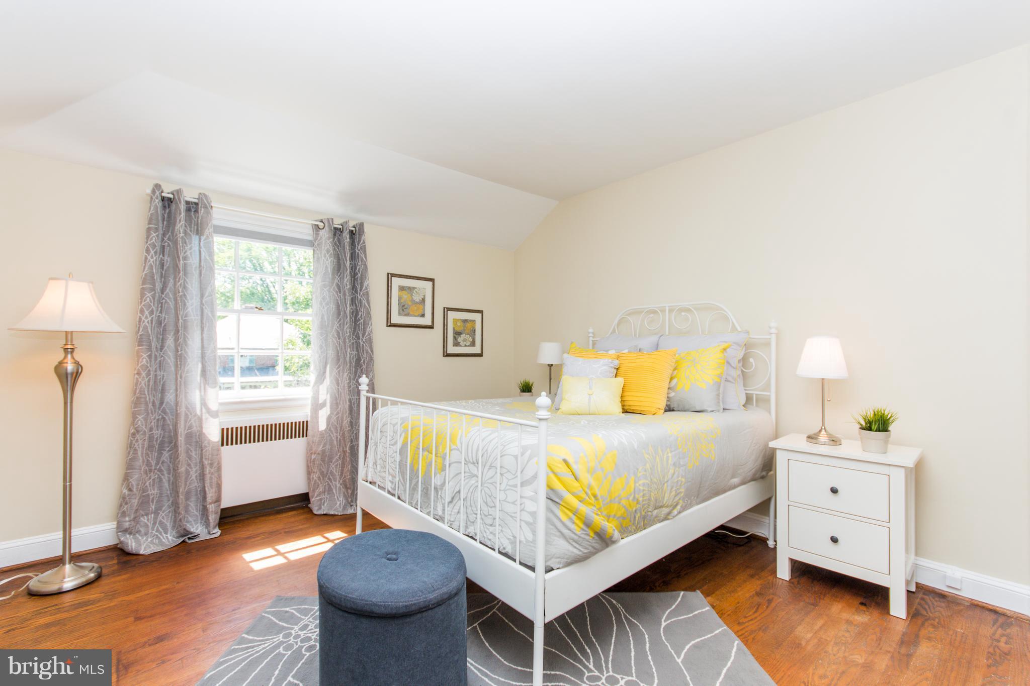 5001 Broadmoor Road Baltimore, MD 21212 - Photo 16 of 26 a bedroom with a bed and wooden floor