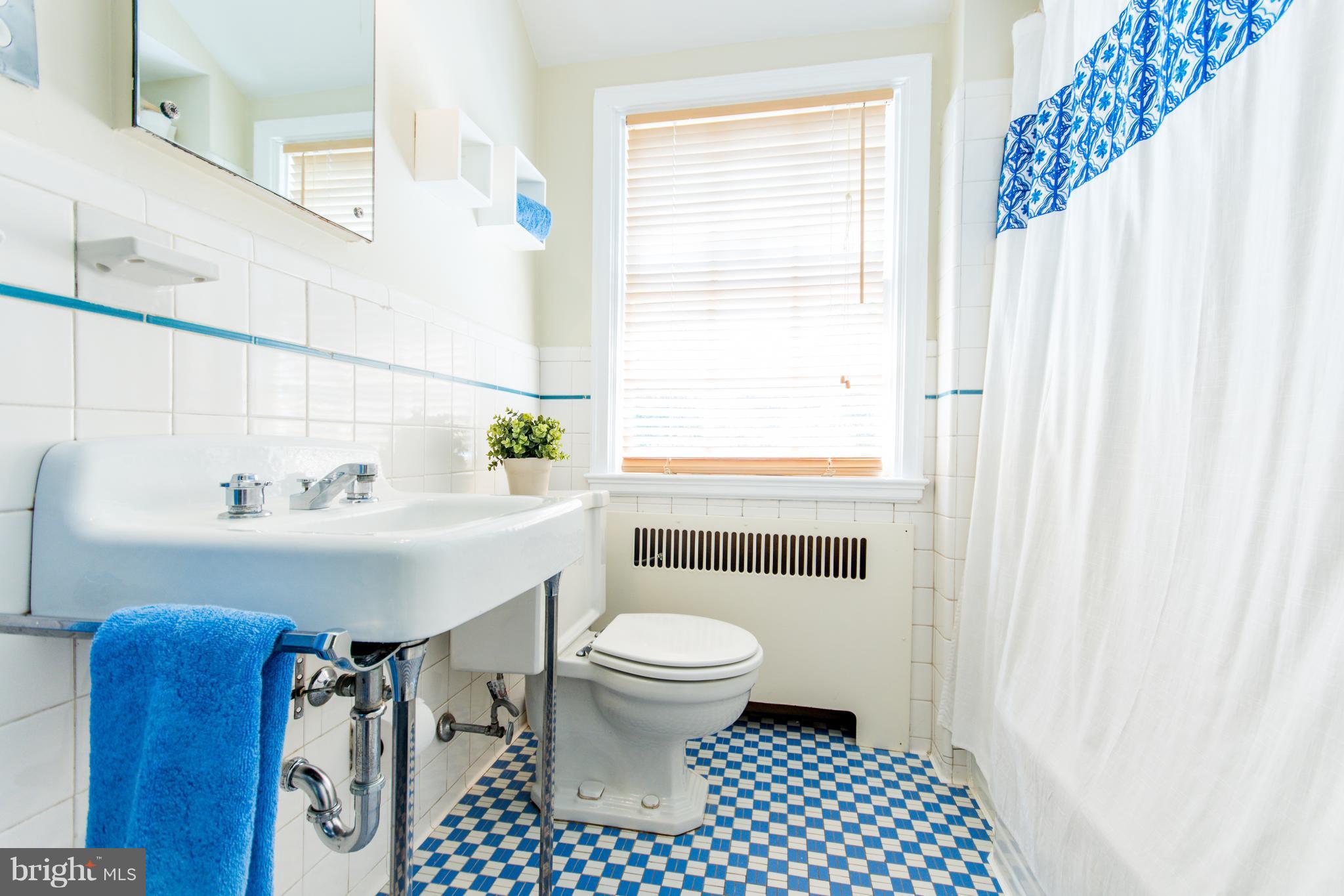 5001 Broadmoor Road Baltimore, MD 21212 - Photo 19 of 26 a bathroom with a sink a toilet and a mirror