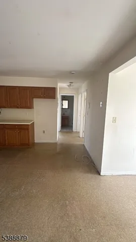 a view of a livingroom with an empty space and a fireplace