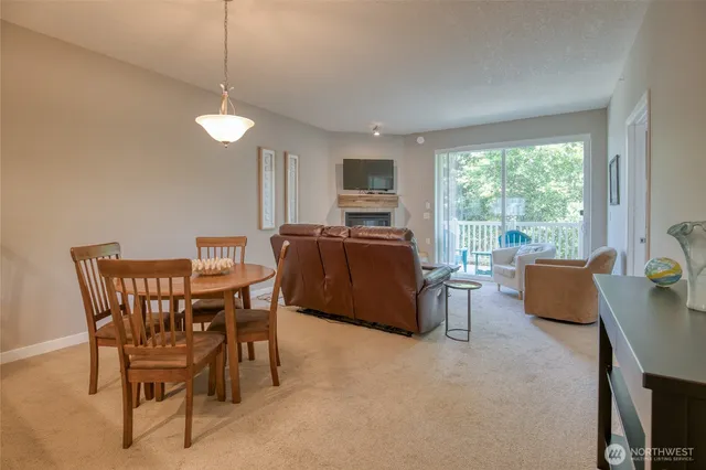 a living room with furniture a flat screen tv and a large window