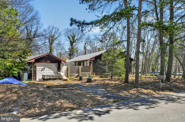 a view of a house with a yard covered in snow