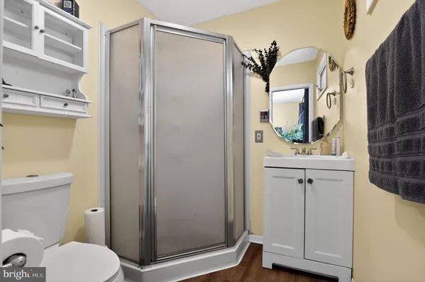 a bathroom with a granite countertop sink toilet and shower