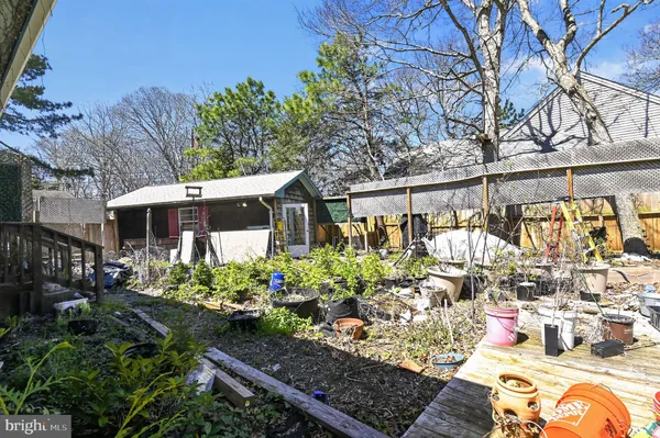 a front view of a house with a yard and a garden