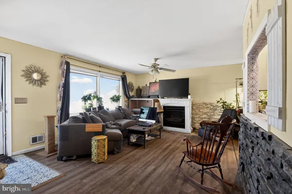 a living room with fireplace furniture and a flat screen tv