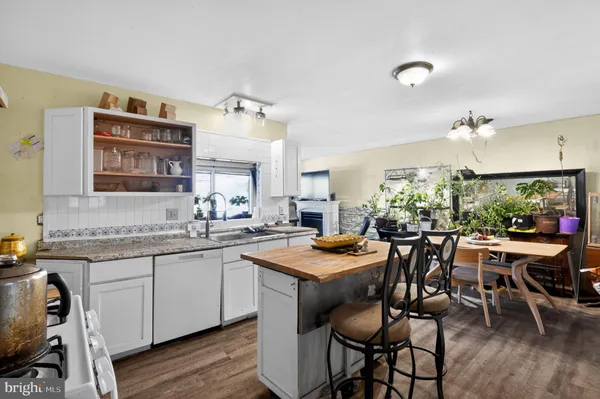 a kitchen with a table and chairs in it