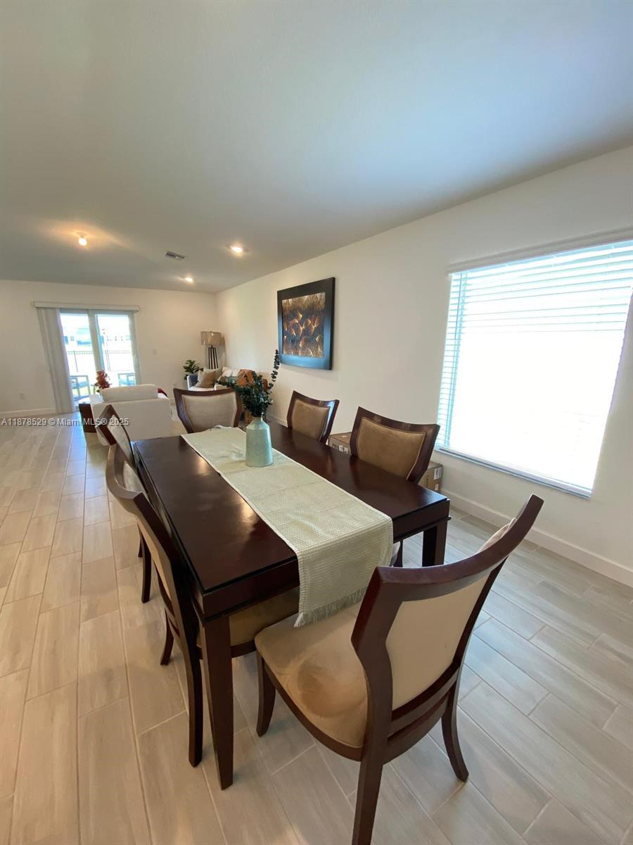 11060 Middle Strm Drive Port St. Lucie, FL 34987 - Photo 13 of 41 a view of a dining room with furniture