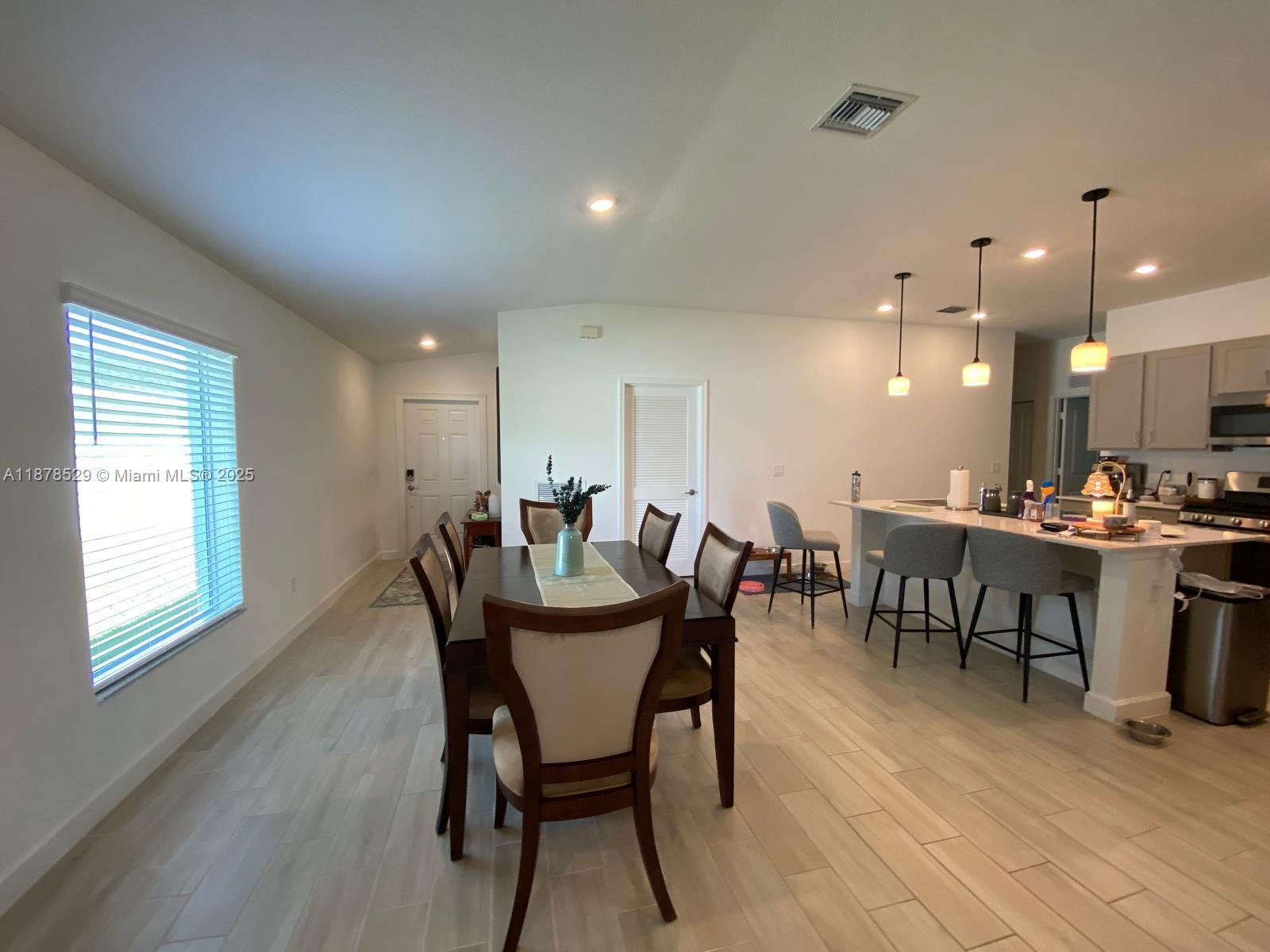 11060 Middle Strm Drive Port St. Lucie, FL 34987 - Photo 14 of 41 a view of a dining room with furniture and wooden floor