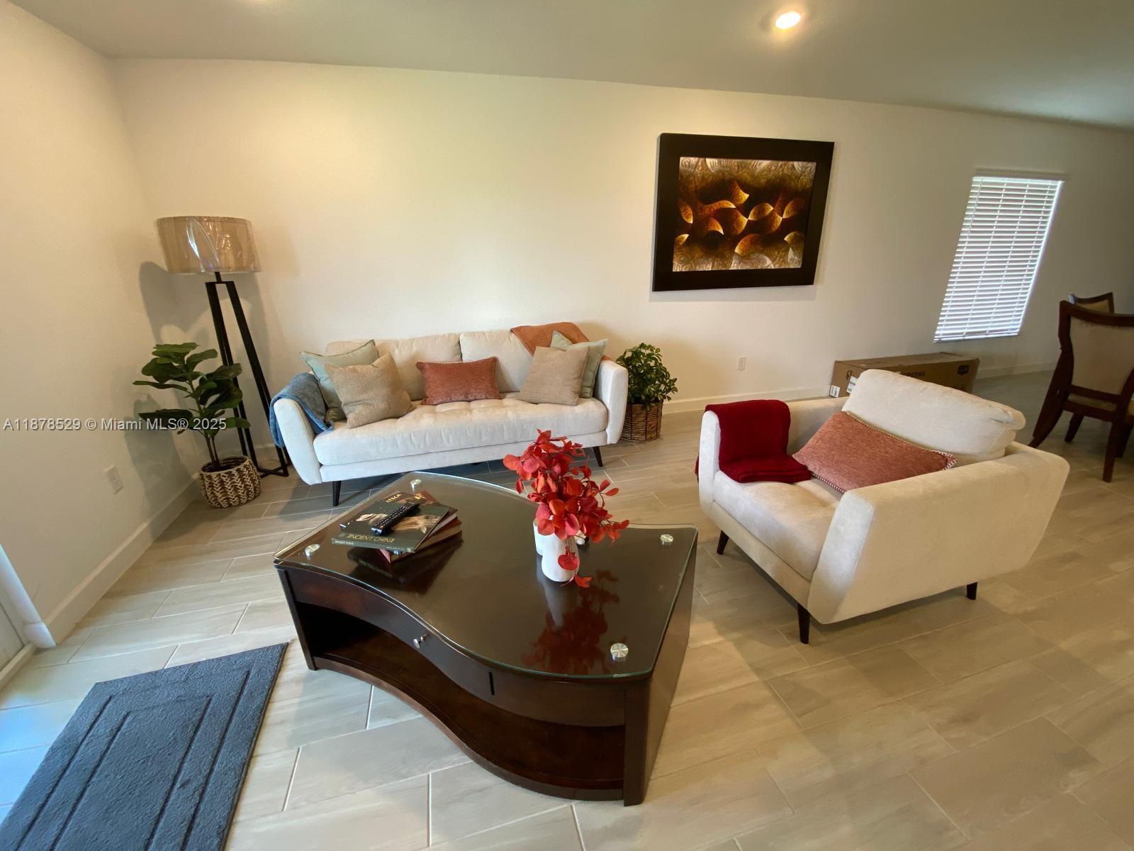 11060 Middle Strm Drive Port St. Lucie, FL 34987 - Photo 15 of 41 a living room with furniture and a wooden floor