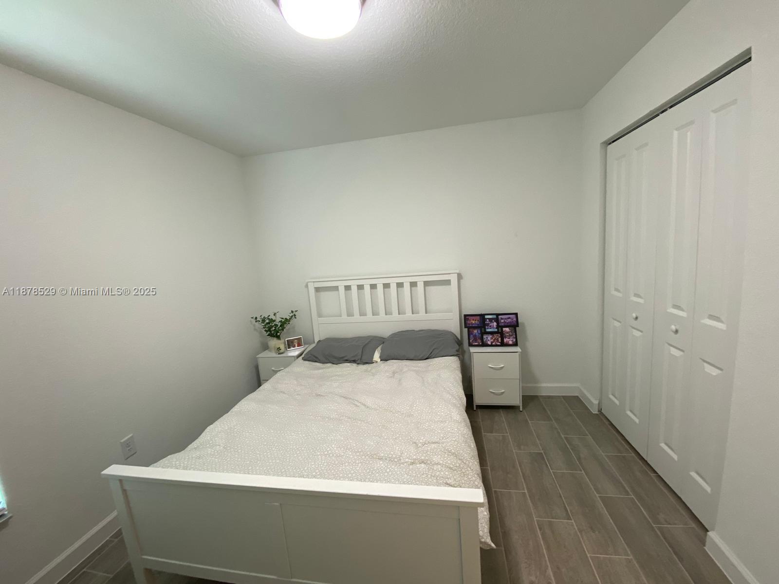 11060 Middle Strm Drive Port St. Lucie, FL 34987 - Photo 18 of 41 a bed sitting in a bathroom next to a window