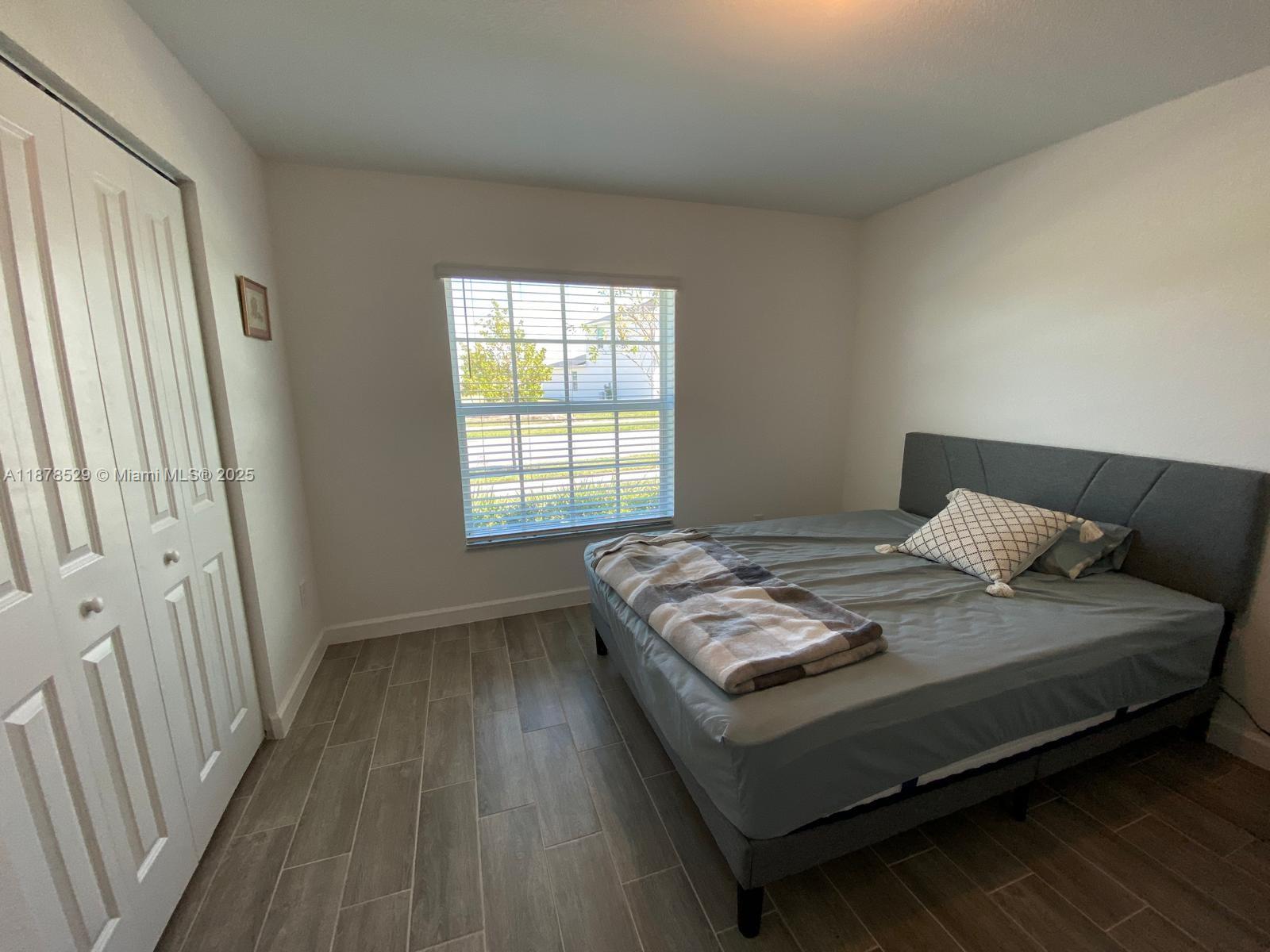 11060 Middle Strm Drive Port St. Lucie, FL 34987 - Photo 24 of 41 a bedroom with a bed and a window