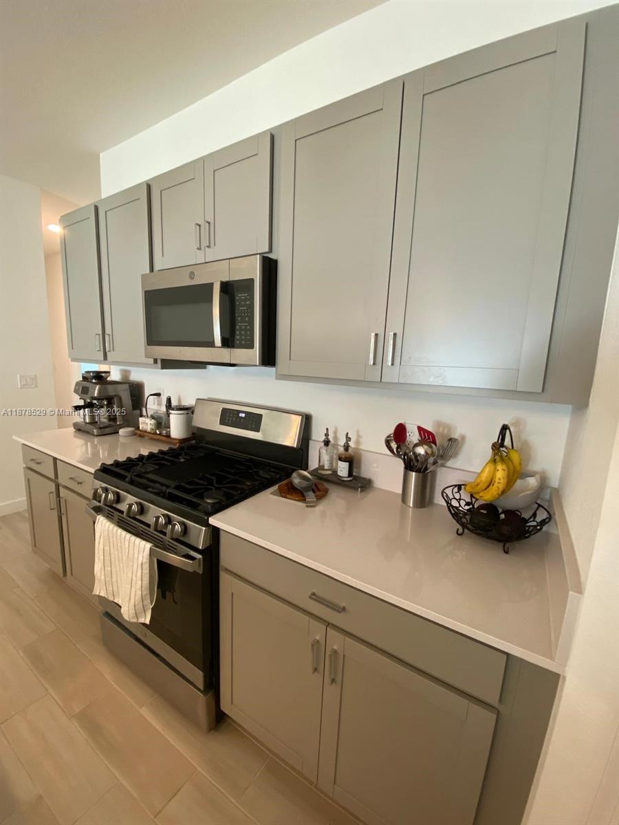 11060 Middle Strm Drive Port St. Lucie, FL 34987 - Photo 26 of 41 a kitchen with sink a stove and cabinets