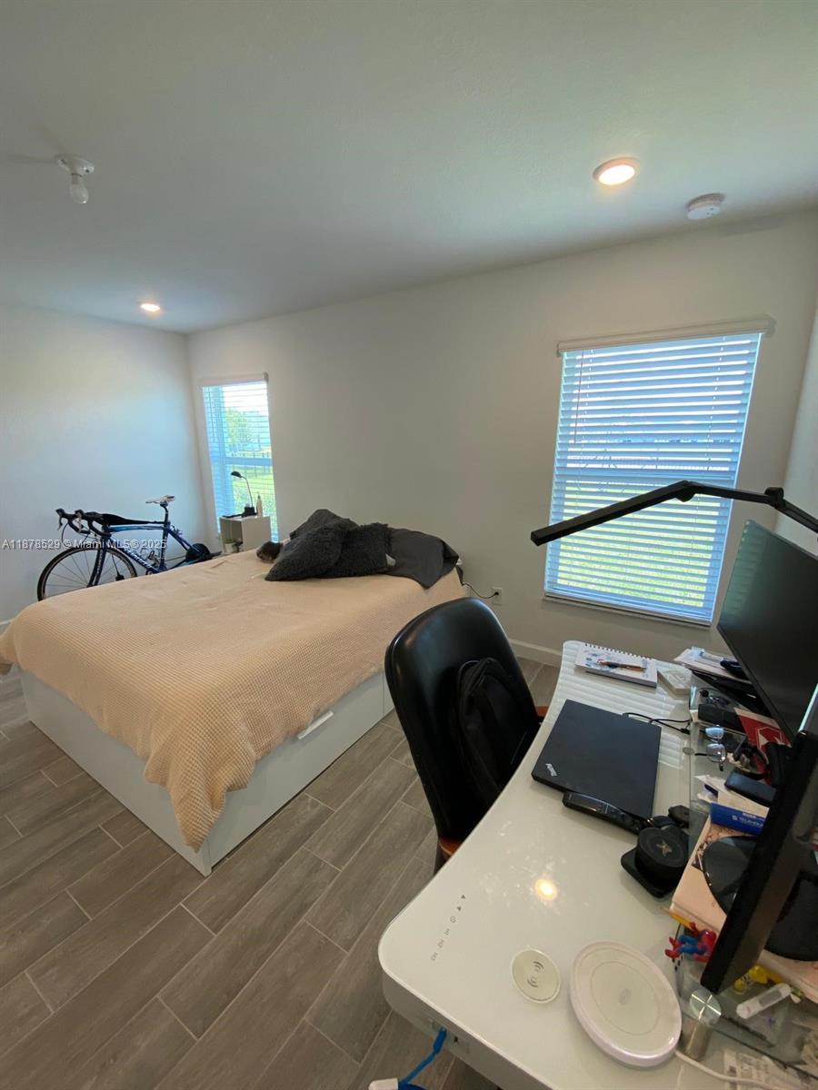 11060 Middle Strm Drive Port St. Lucie, FL 34987 - Photo 28 of 41 a bedroom with a bed and a computer on the desk