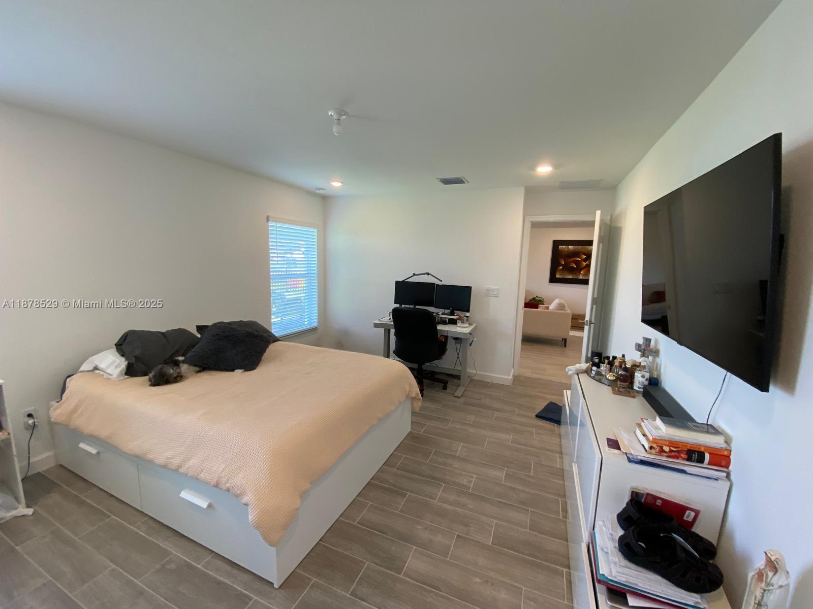 11060 Middle Strm Drive Port St. Lucie, FL 34987 - Photo 29 of 41 a bedroom with a bed and a flat screen tv