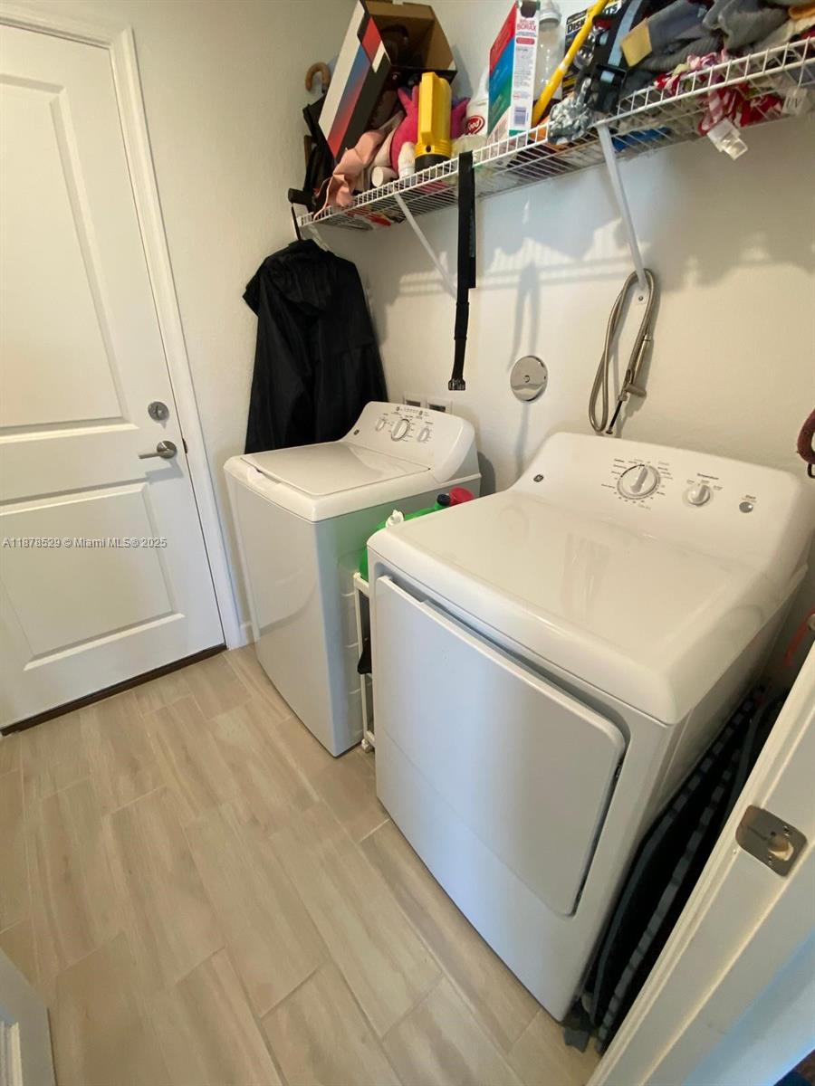 11060 Middle Strm Drive Port St. Lucie, FL 34987 - Photo 33 of 41 a utility room with dryer and washer