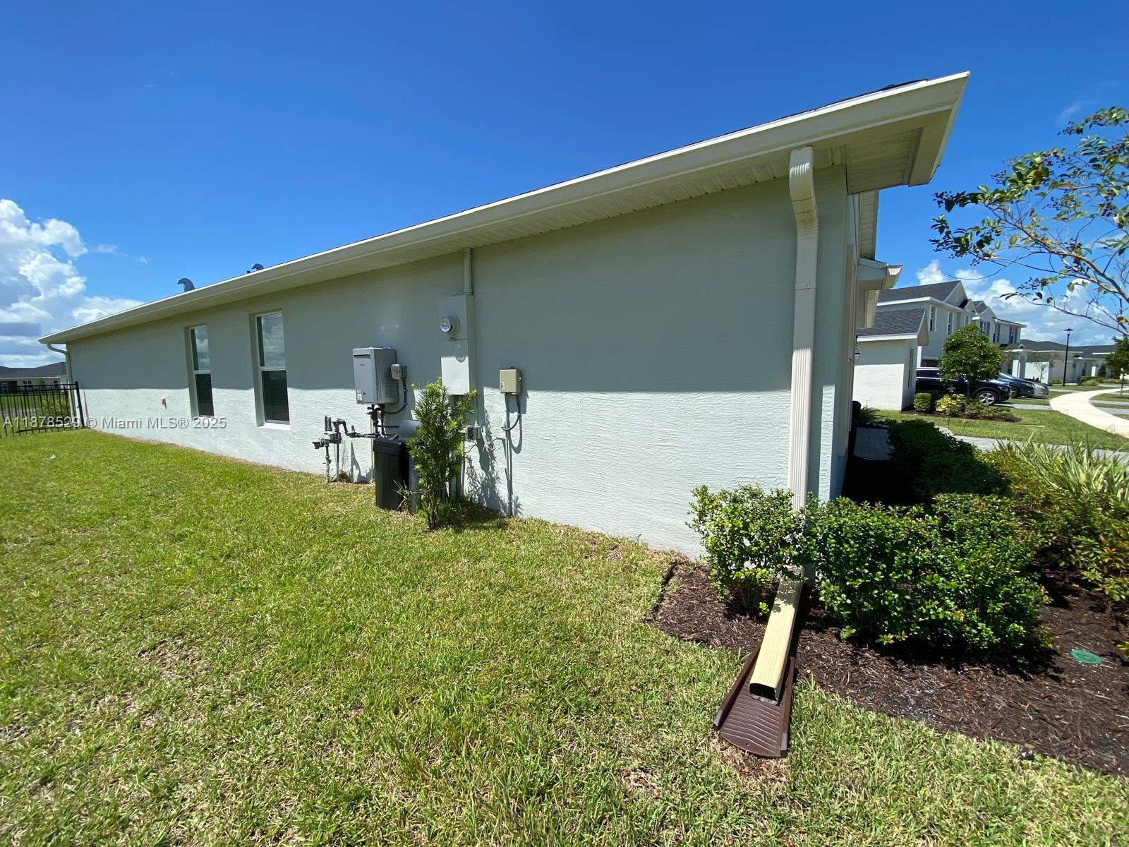11060 Middle Strm Drive Port St. Lucie, FL 34987 - Photo 38 of 41 a front view of a house with garden