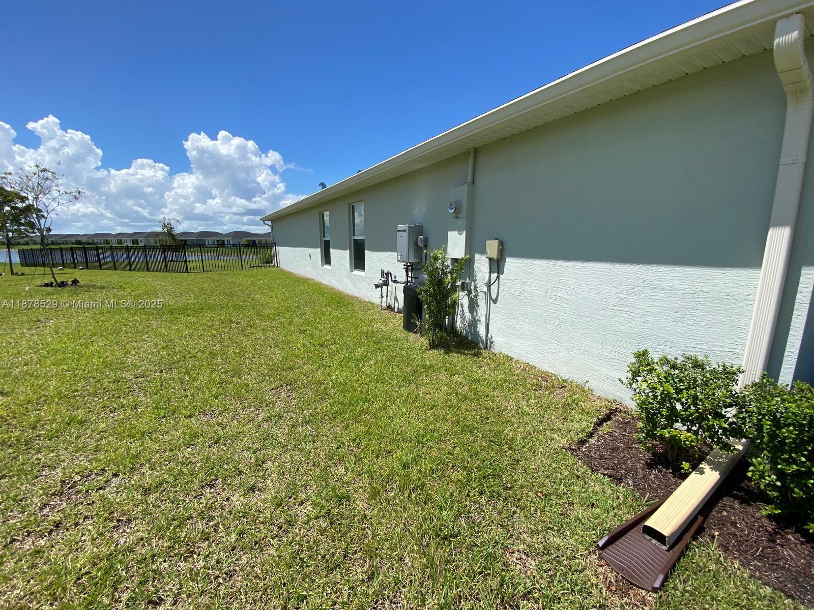 11060 Middle Strm Drive Port St. Lucie, FL 34987 - Photo 39 of 41 a backyard of a house with lots of green space