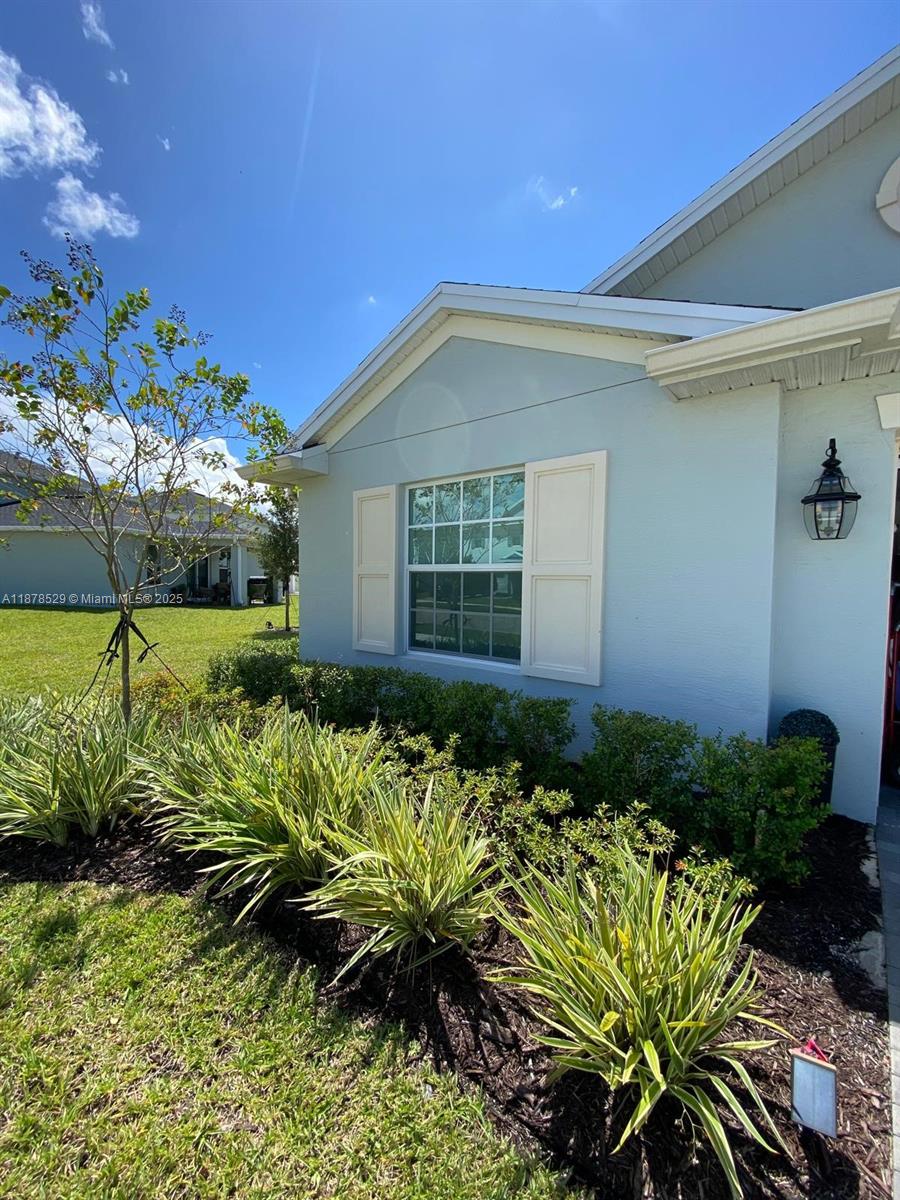 11060 Middle Strm Drive Port St. Lucie, FL 34987 - Photo 41 of 41 a bunch of flowers in front of house