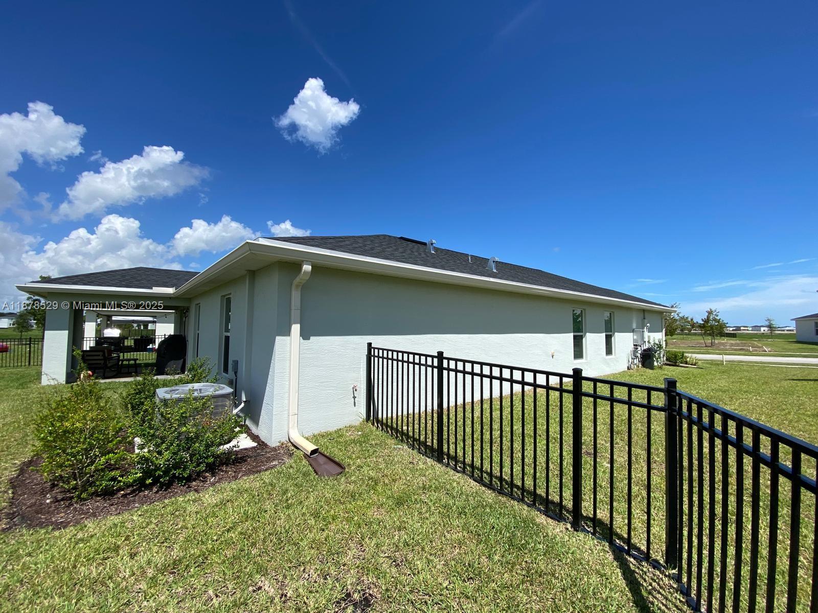 11060 Middle Strm Drive Port St. Lucie, FL 34987 - Photo 7 of 41 a view of a house with a yard
