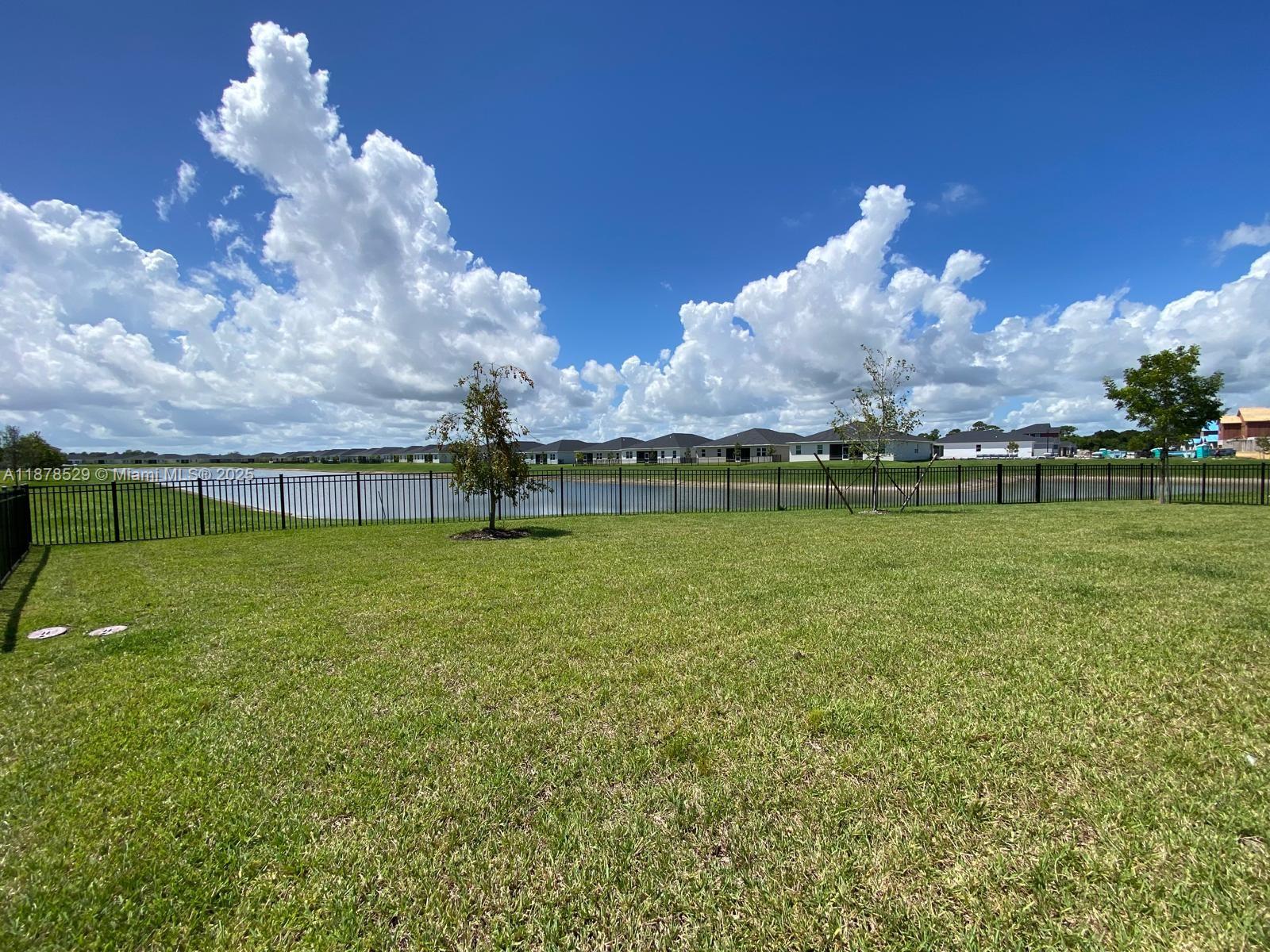11060 Middle Strm Drive Port St. Lucie, FL 34987 - Photo 10 of 41 a view of a golf course with a lake