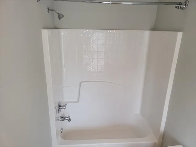 a bathroom with a shower and a bath tub