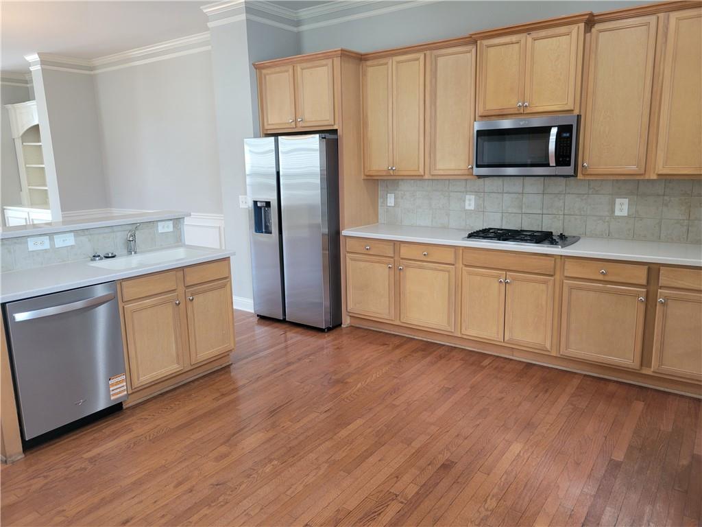 2098 Silas Way Northwest Atlanta, GA 30318 - Photo 3 of 18 a kitchen with stainless steel appliances a stove a sink cabinets and a wooden floor