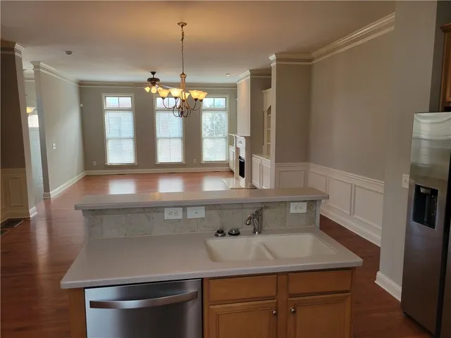 a kitchen with a sink and a refrigerator