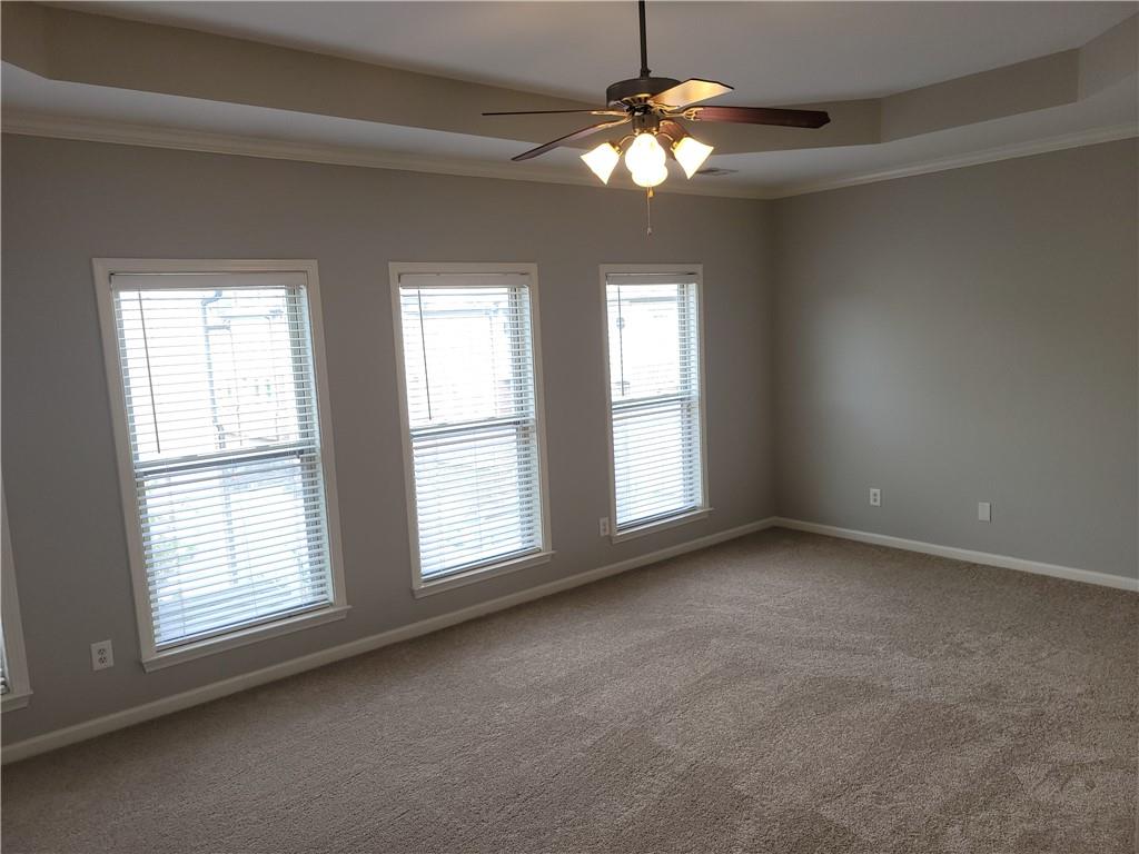 2098 Silas Way Northwest Atlanta, GA 30318 - Photo 9 of 18 an empty room with chandelier fan and windows