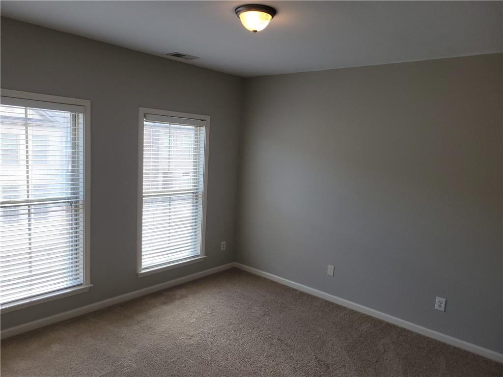 2098 Silas Way Northwest Atlanta, GA 30318 - Photo 10 of 18 an empty room with a window and a fan
