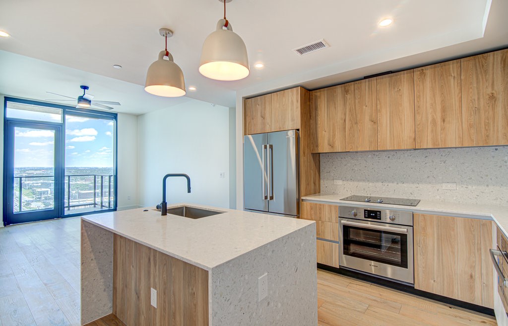 84 East Avenue, Unit 3003 Austin, TX 78701 - Photo 1 of 1 a kitchen with a stove a sink and a refrigerator