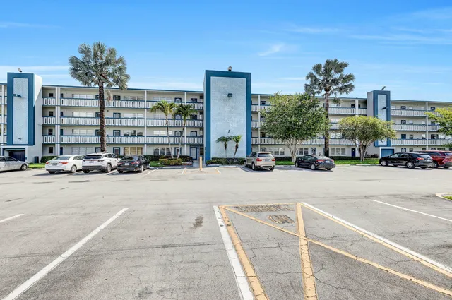 a view of a park with multi story residential apartment building in the back