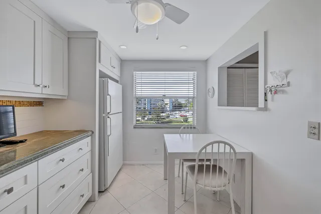 a view of a kitchen area with a table and chairs