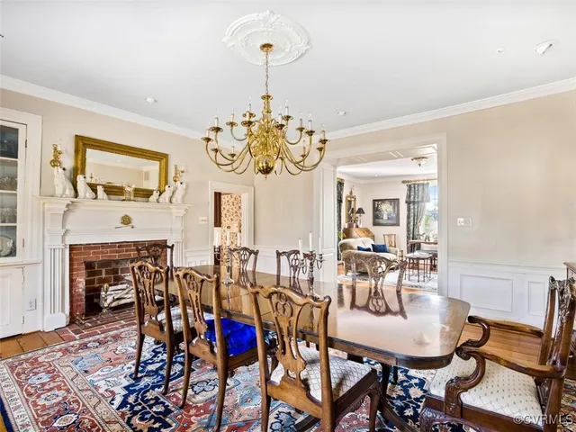 a view of a dining room with furniture and chandelier