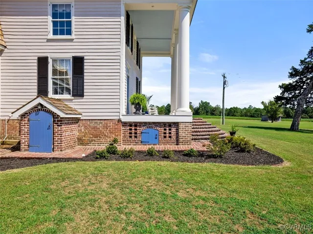 a view of a house with a yard and a fence