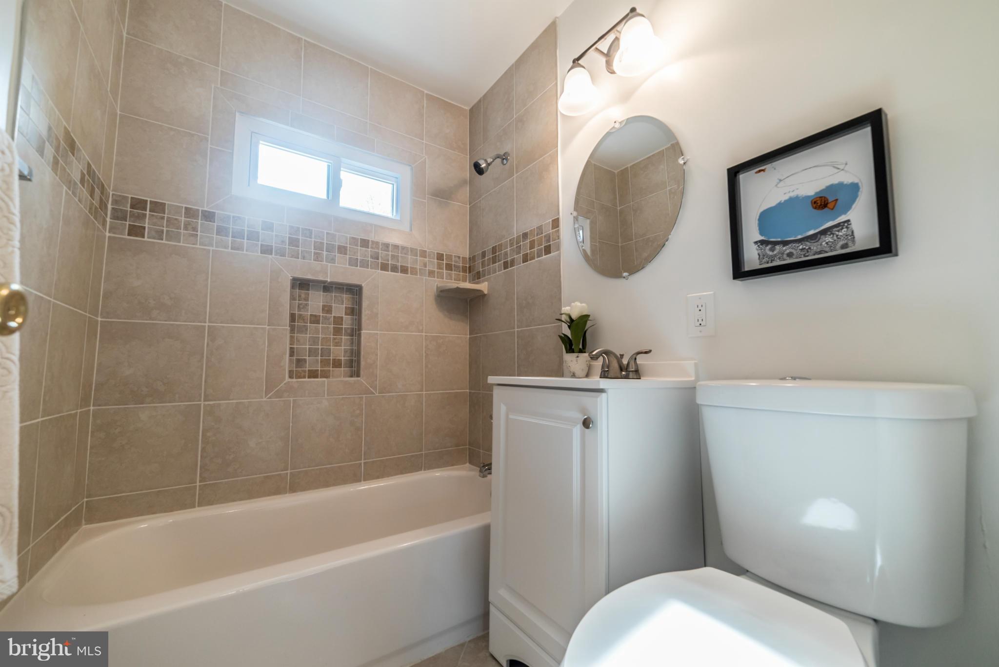 4106 Sampson Road Silver Spring, MD 20906 - Photo 11 of 30 a white toilet sitting next to a bathtub