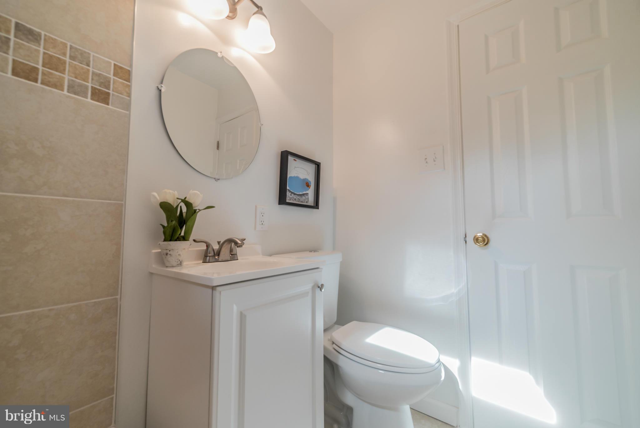 4106 Sampson Road Silver Spring, MD 20906 - Photo 12 of 30 a bathroom with a sink toilet and a mirror