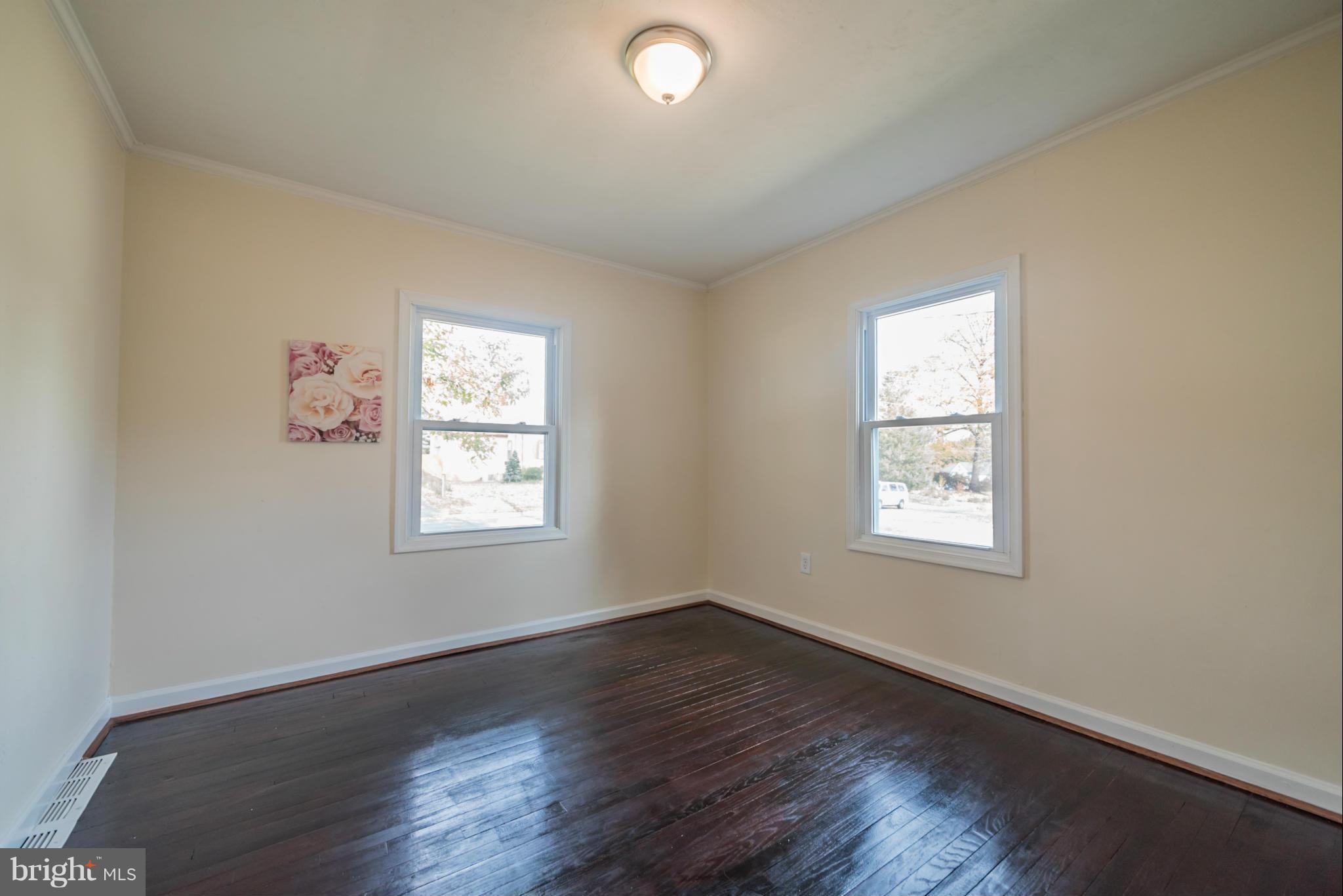 4106 Sampson Road Silver Spring, MD 20906 - Photo 14 of 30 an empty room with wooden floor and windows