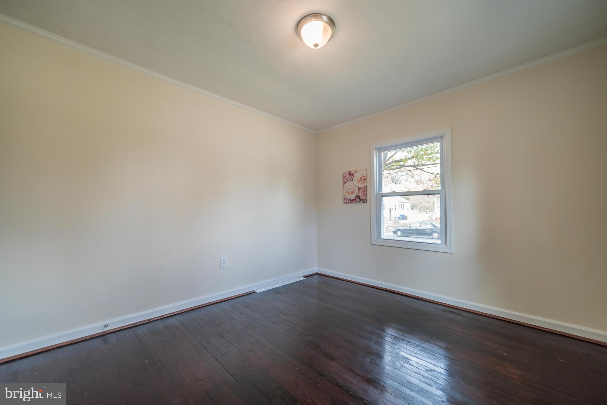 4106 Sampson Road Silver Spring, MD 20906 - Photo 16 of 30 an empty room with wooden floor and windows