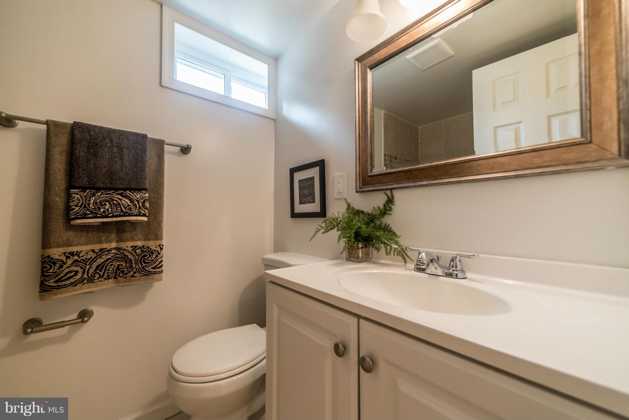 4106 Sampson Road Silver Spring, MD 20906 - Photo 23 of 30 a bathroom with a sink a toilet and mirror