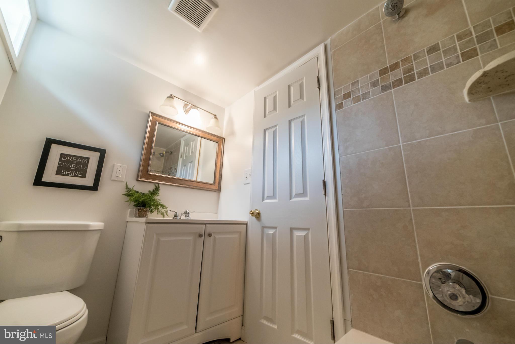 4106 Sampson Road Silver Spring, MD 20906 - Photo 24 of 30 a bathroom with a toilet a sink and mirror