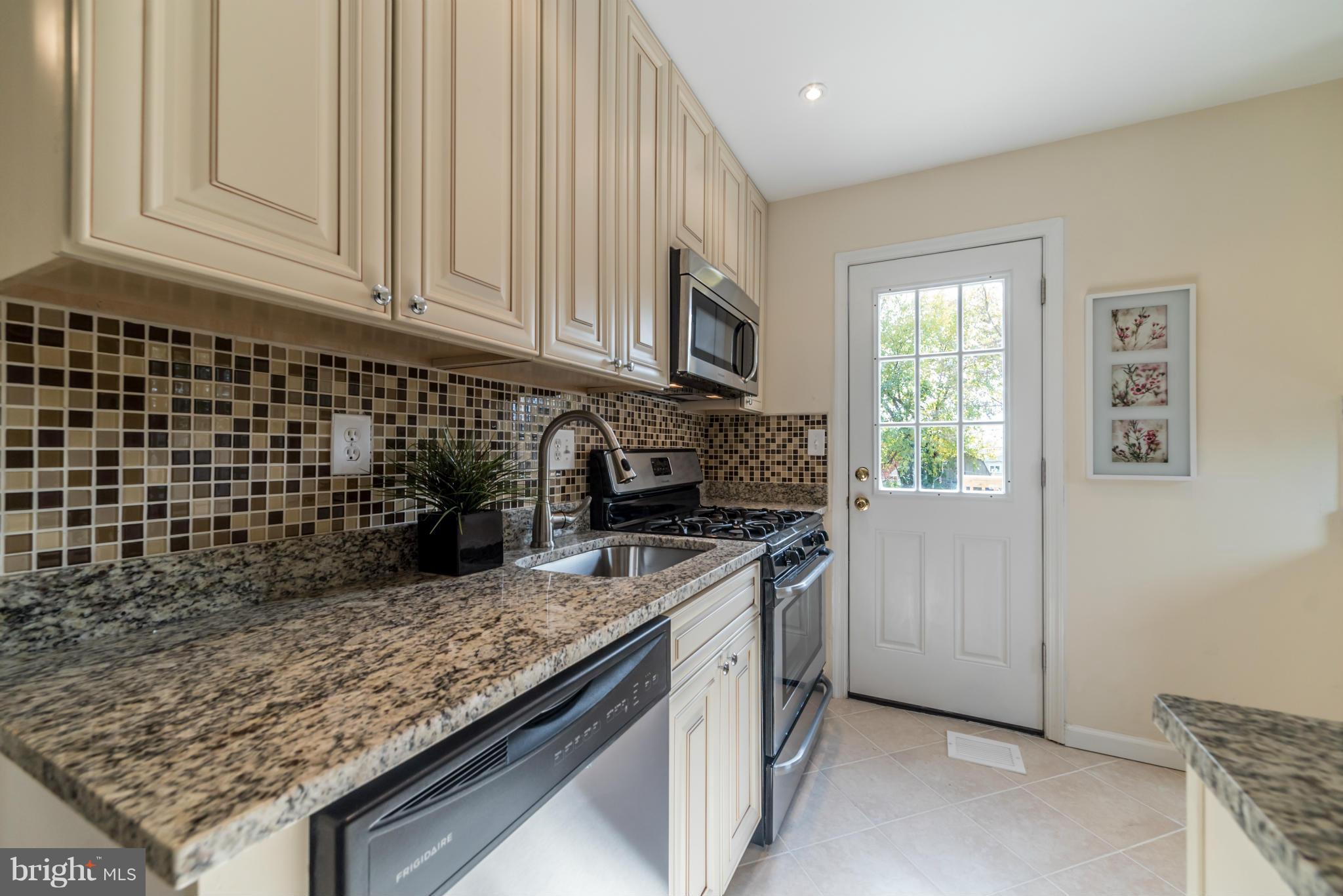 4106 Sampson Road Silver Spring, MD 20906 - Photo 5 of 30 a kitchen with granite countertop a stove sink and cabinets