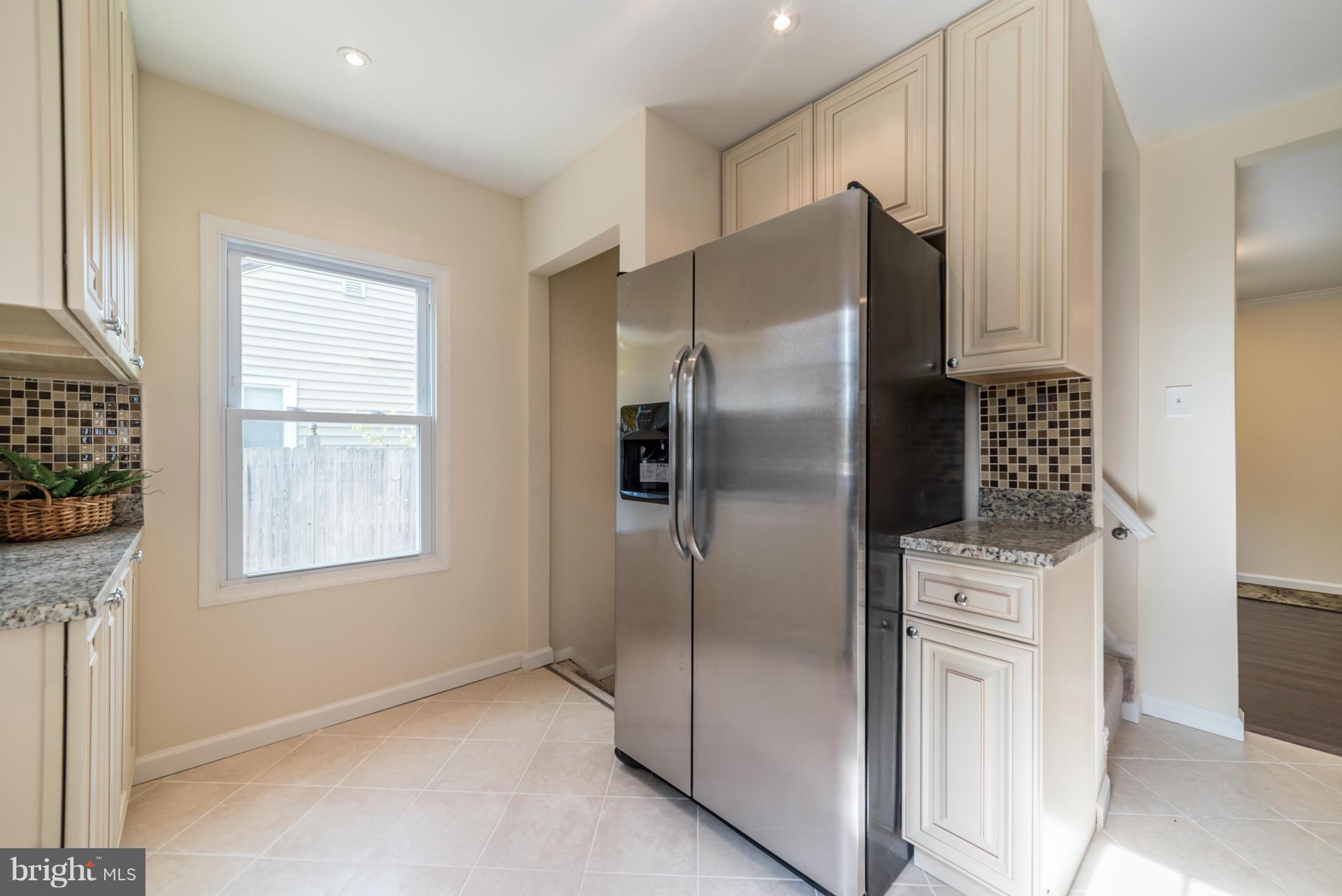 4106 Sampson Road Silver Spring, MD 20906 - Photo 7 of 30 a kitchen with stainless steel appliances granite countertop a refrigerator and a stove