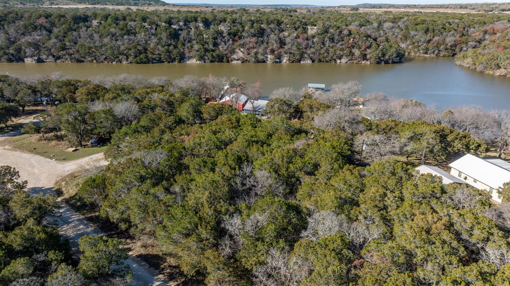 9037 Lacy Road Graford, TX 76449 - Photo 18 of 36 a view of a lake with a mountain in the background