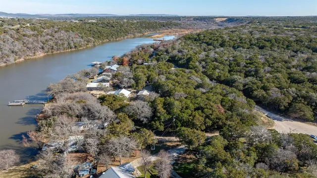 an aerial view of a houses with a lake