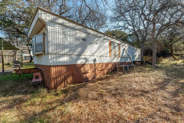 a view of backyard with deck and seating area