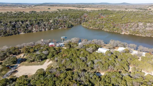 an aerial view of a houses with a lake view