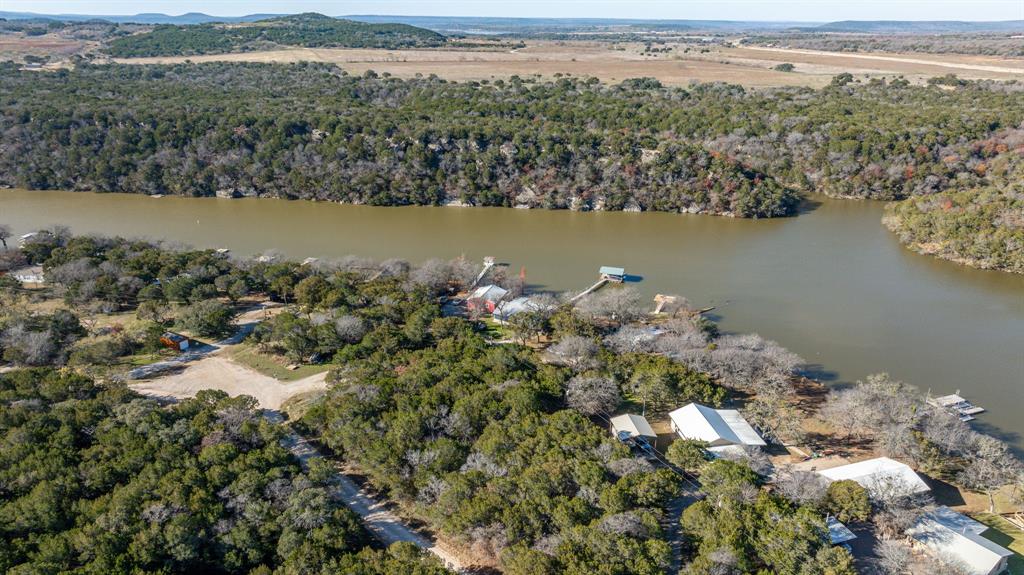 9037 Lacy Road Graford, TX 76449 - Photo 6 of 36 a view of a lake with a mountain in the background
