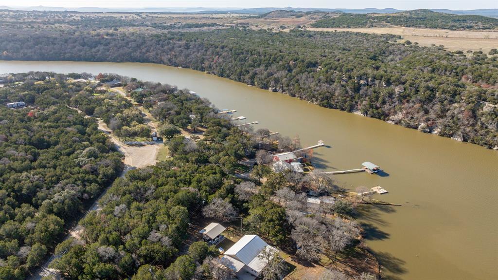 9037 Lacy Road Graford, TX 76449 - Photo 7 of 36 an aerial view of a house with a yard and lake view